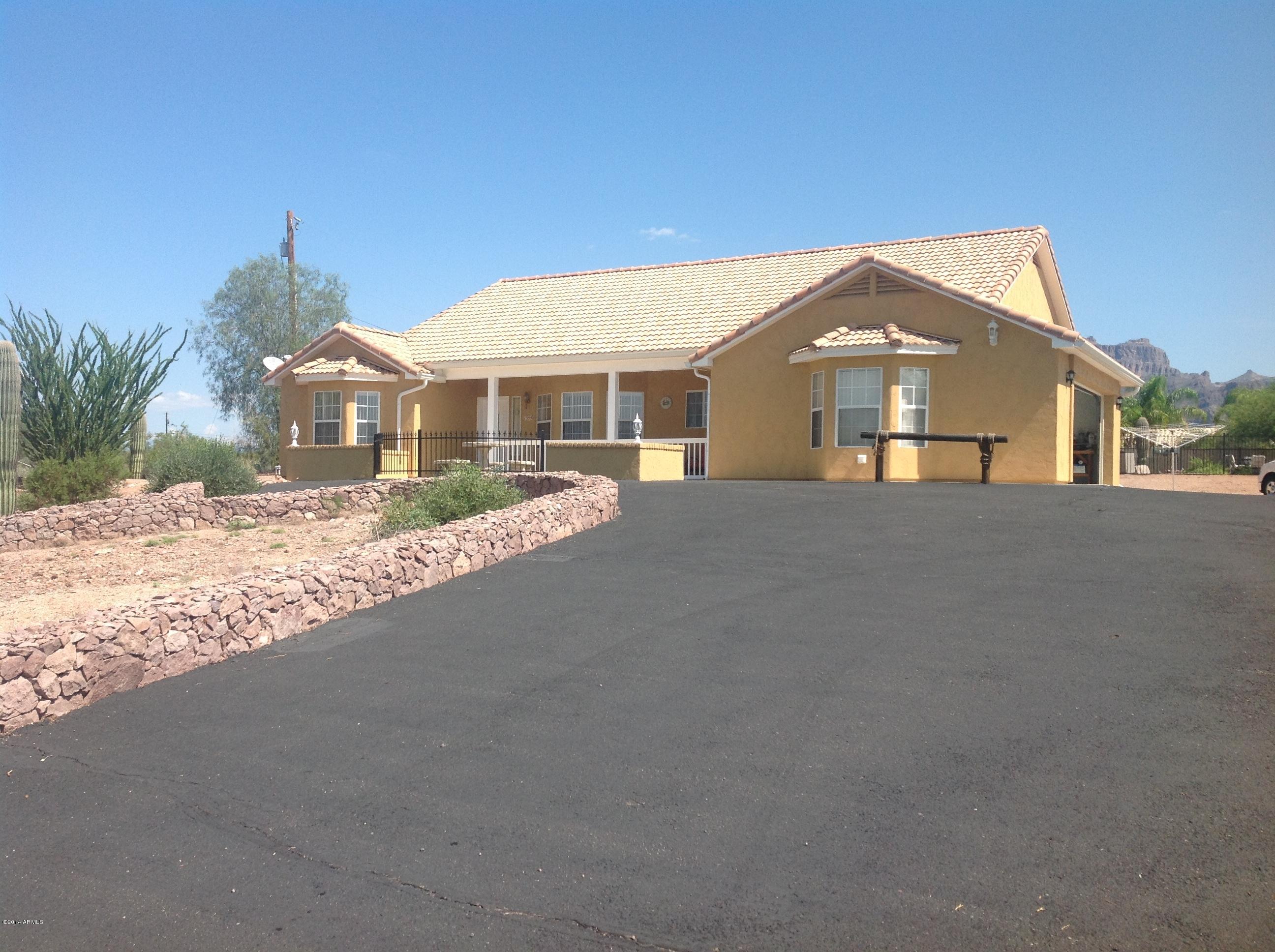 1355 North Acacia Road Apache Junction, AZ 85119 - Photo 1 of 45 a front view of a house with a yard