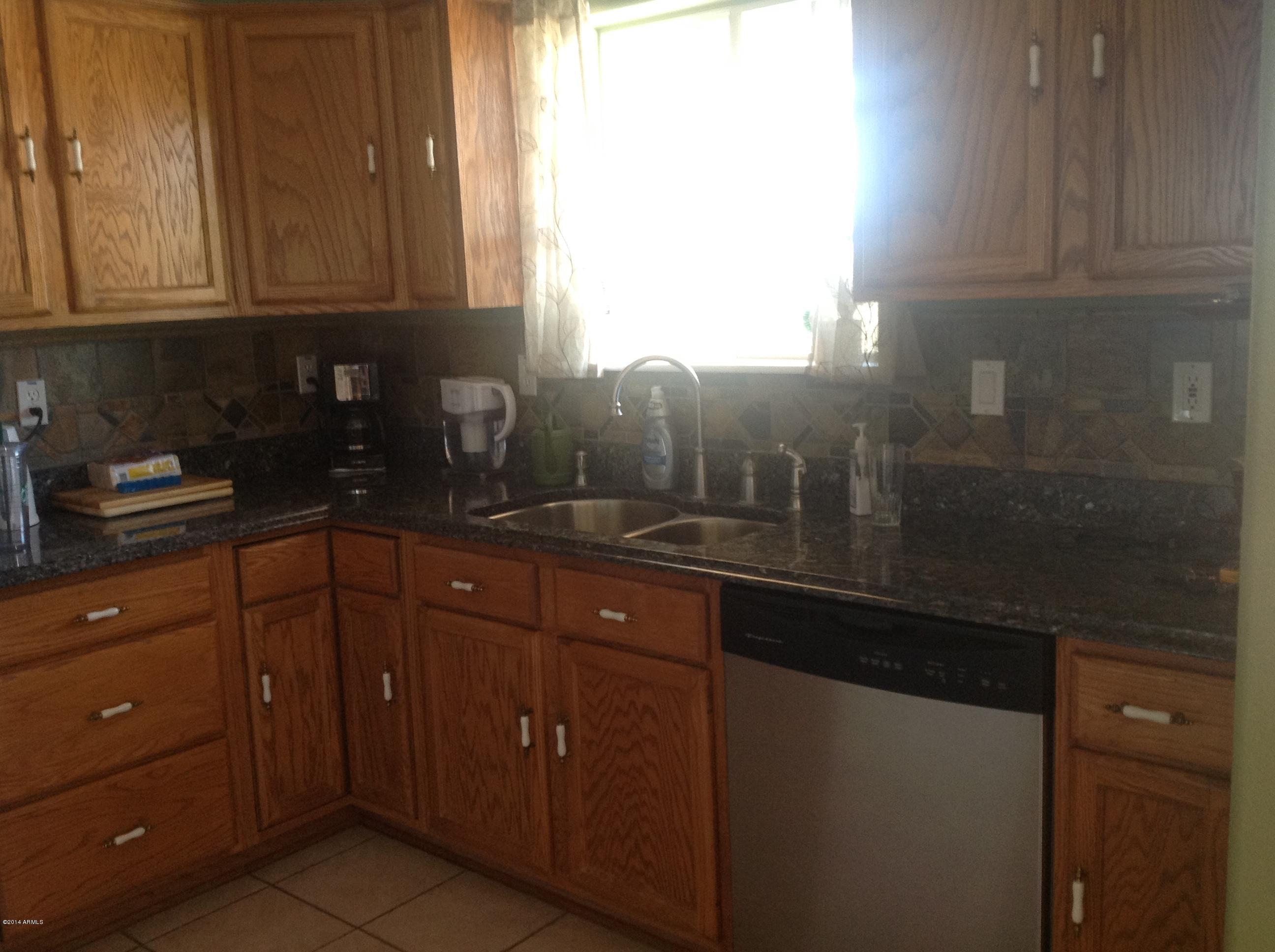 1355 North Acacia Road Apache Junction, AZ 85119 - Photo 11 of 45 a kitchen with sink and cabinets