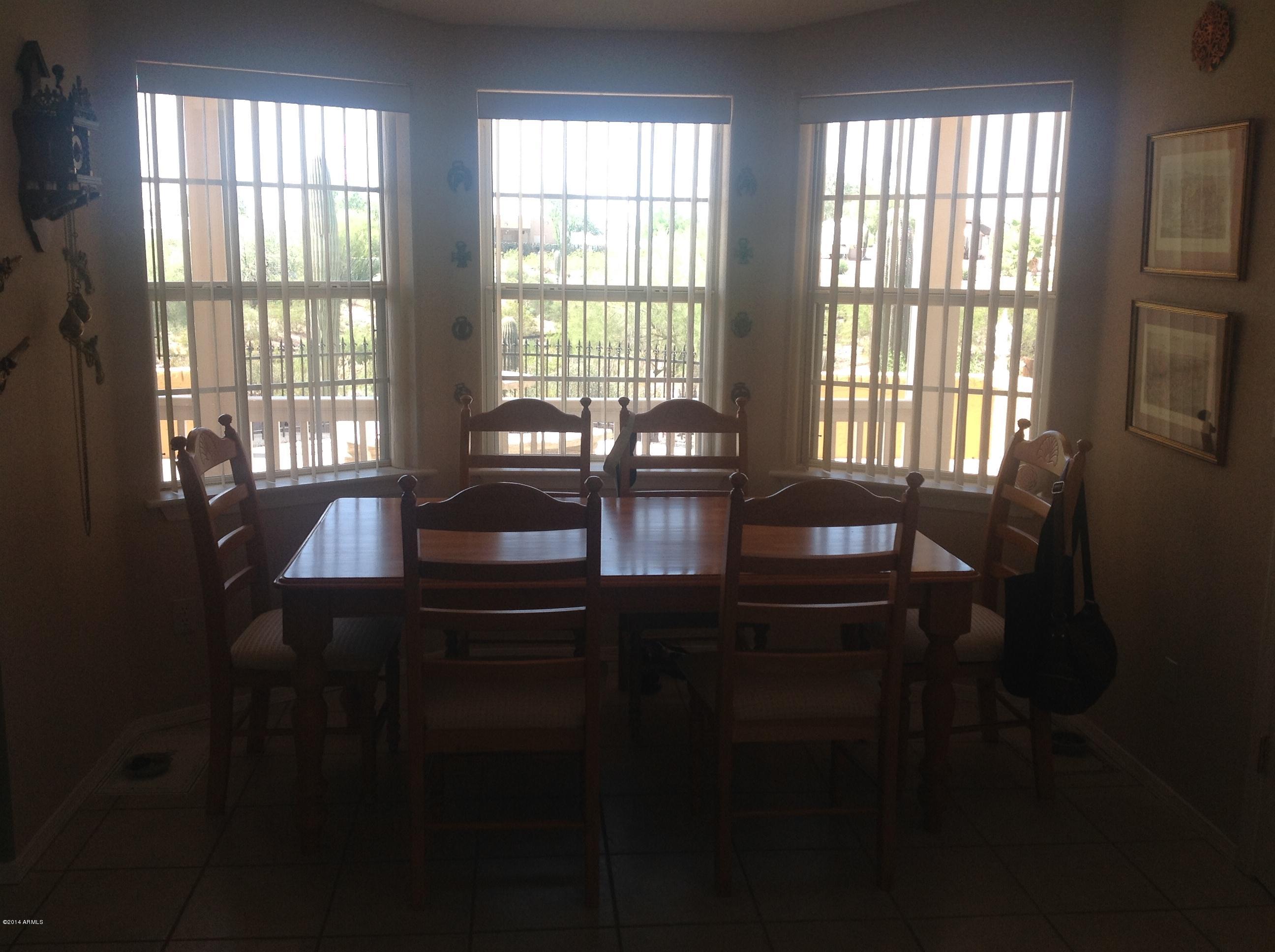 1355 North Acacia Road Apache Junction, AZ 85119 - Photo 12 of 45 a dining room with furniture and windows