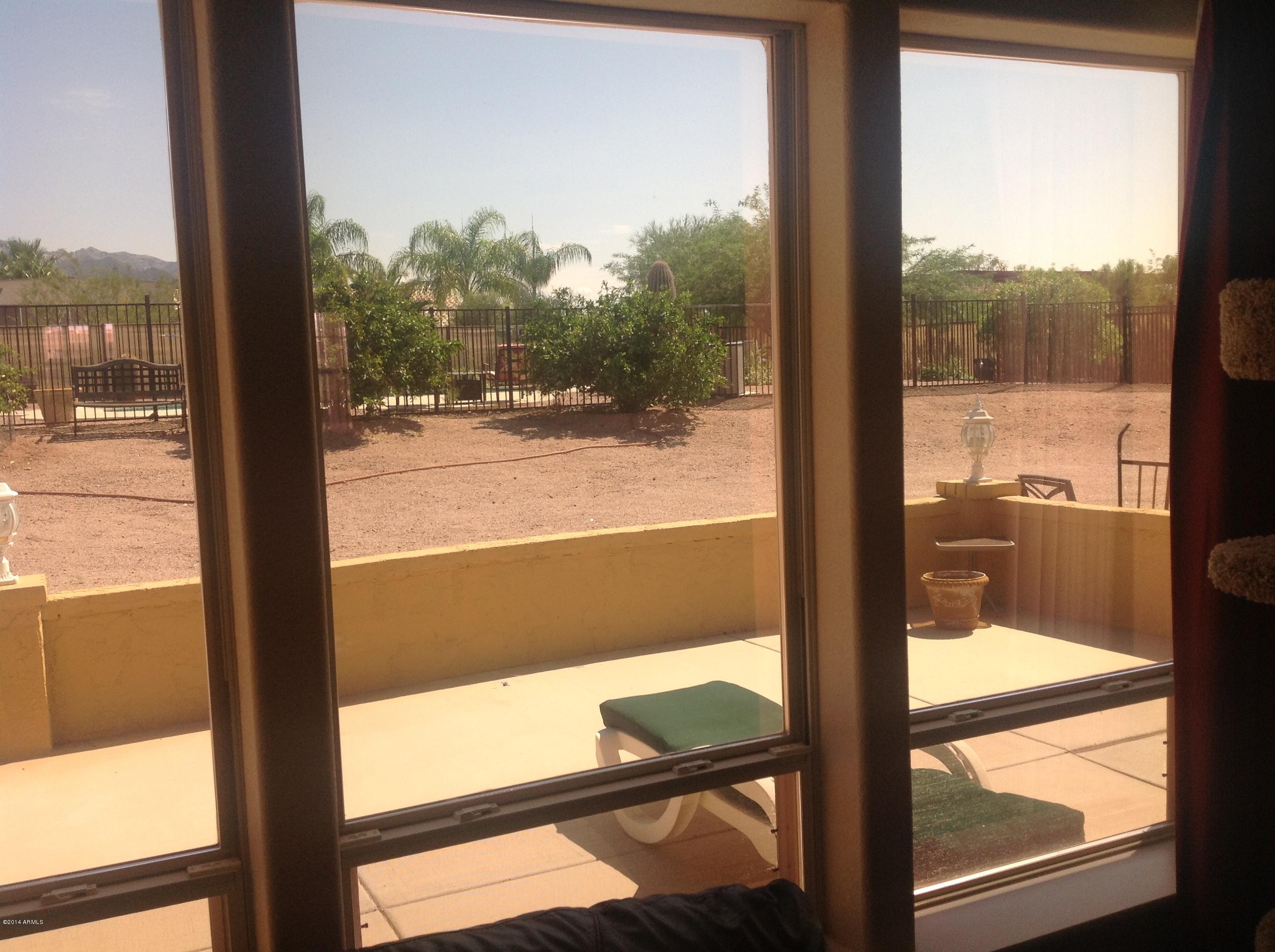 1355 North Acacia Road Apache Junction, AZ 85119 - Photo 14 of 45 a view of a glass door with a from a window