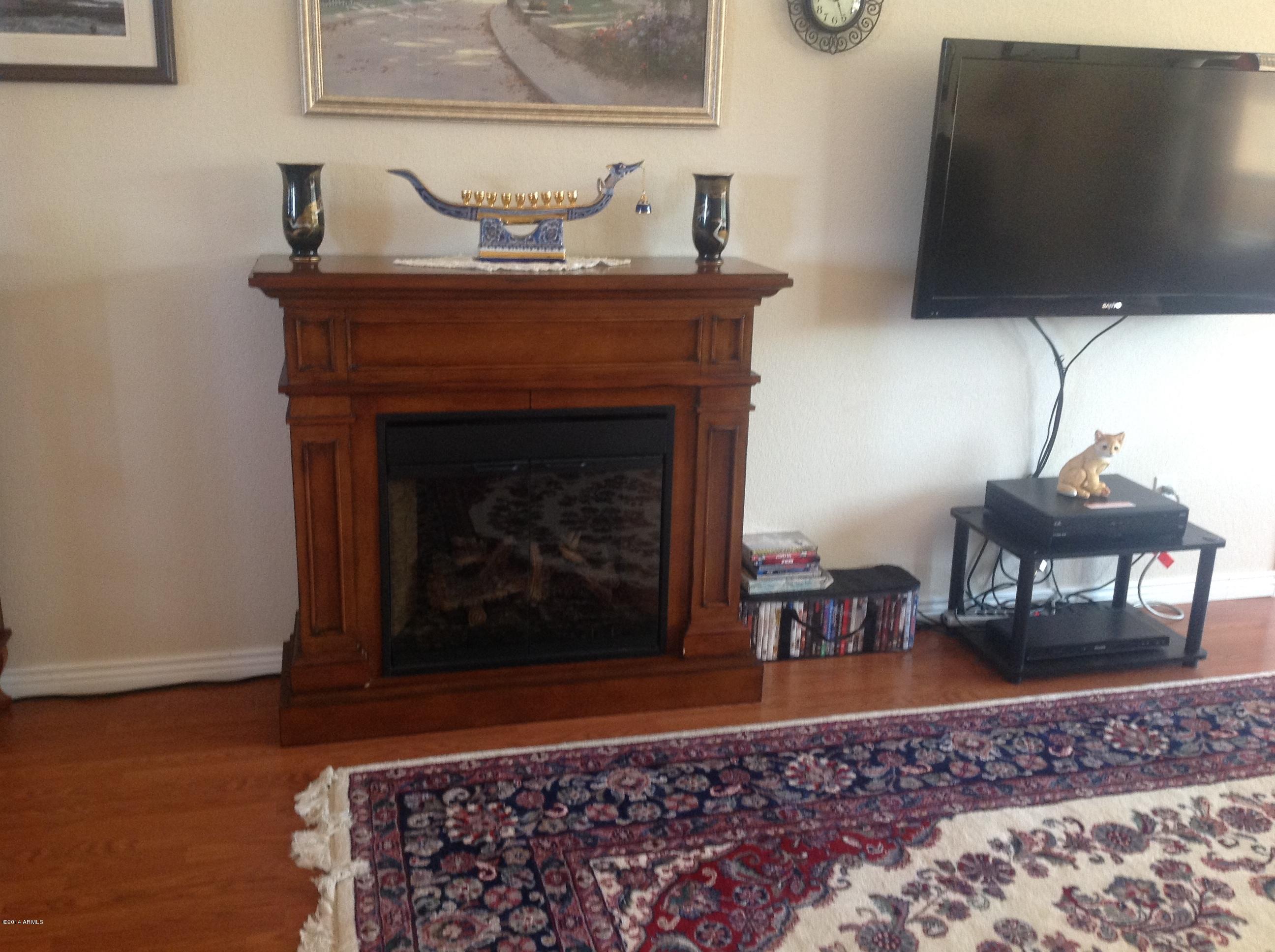 1355 North Acacia Road Apache Junction, AZ 85119 - Photo 20 of 45 a living room with furniture and a fireplace