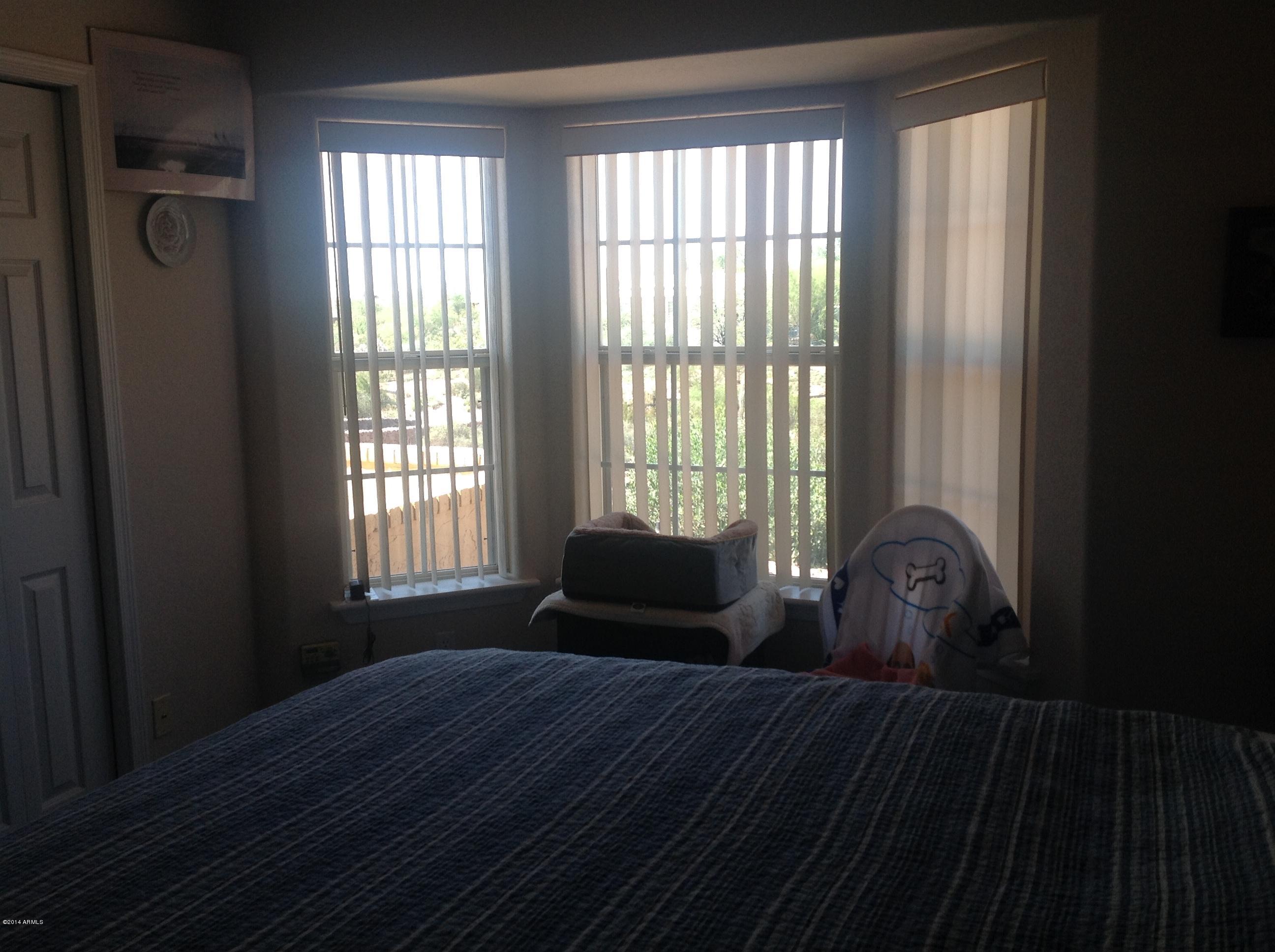 1355 North Acacia Road Apache Junction, AZ 85119 - Photo 23 of 45 a bedroom with a bed and window