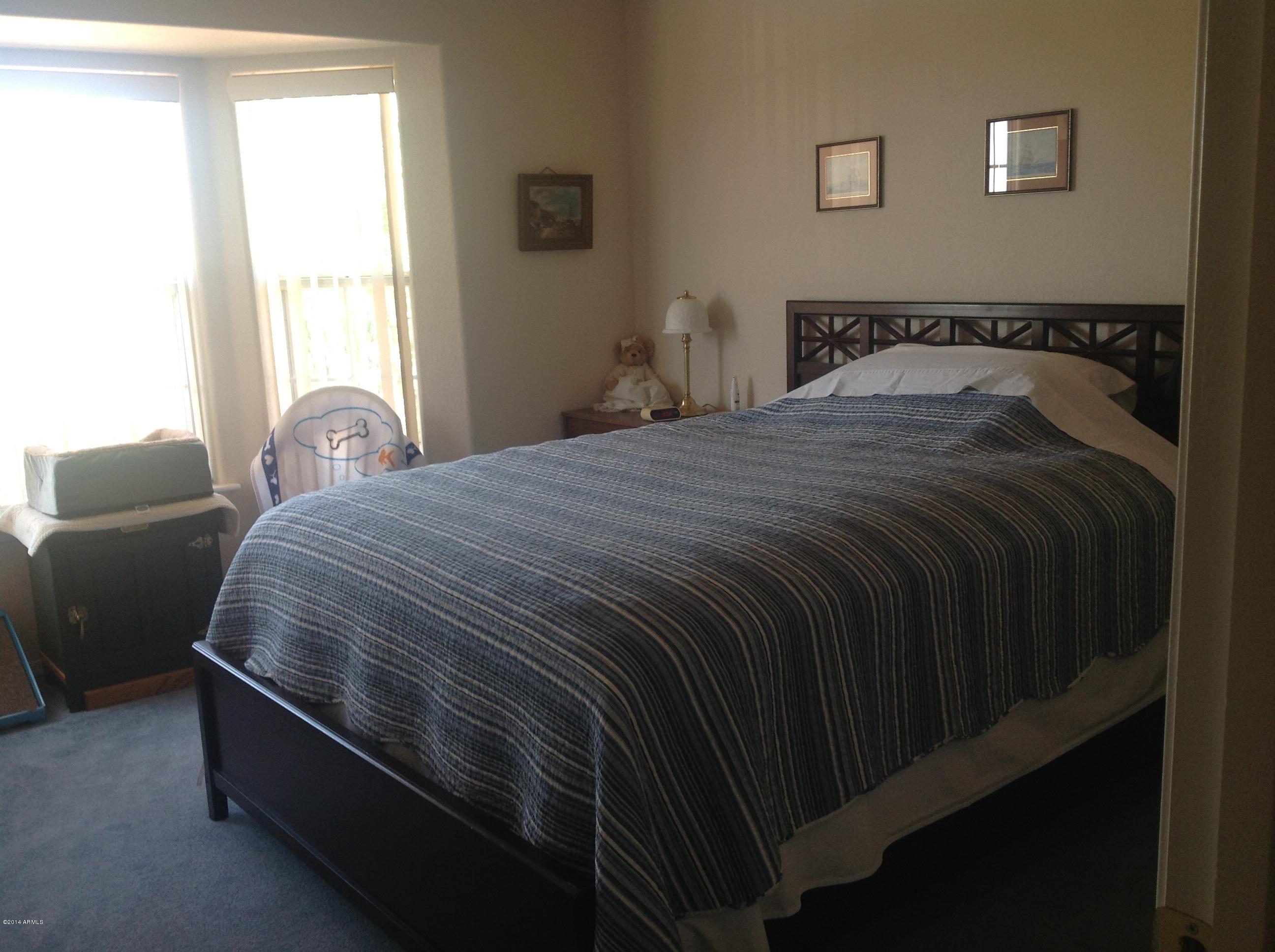 1355 North Acacia Road Apache Junction, AZ 85119 - Photo 24 of 45 a bedroom with a bed and a window