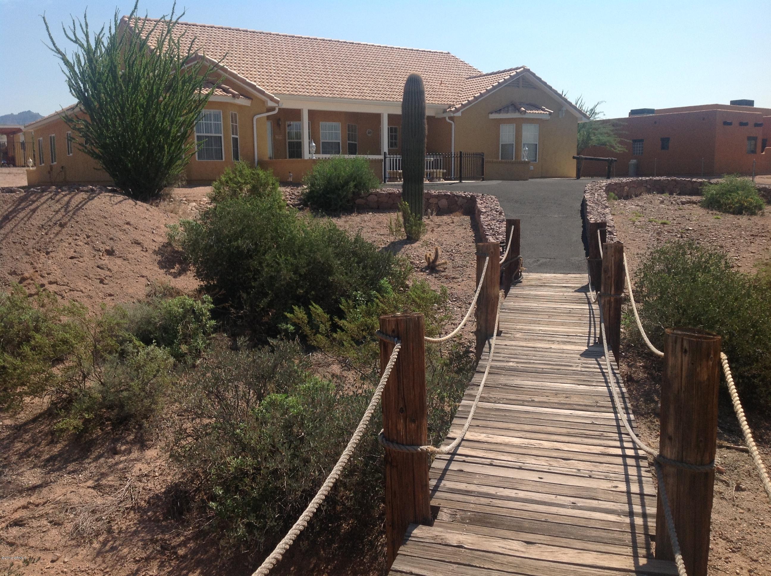 1355 North Acacia Road Apache Junction, AZ 85119 - Photo 44 of 45 a view of a house with wooden fence