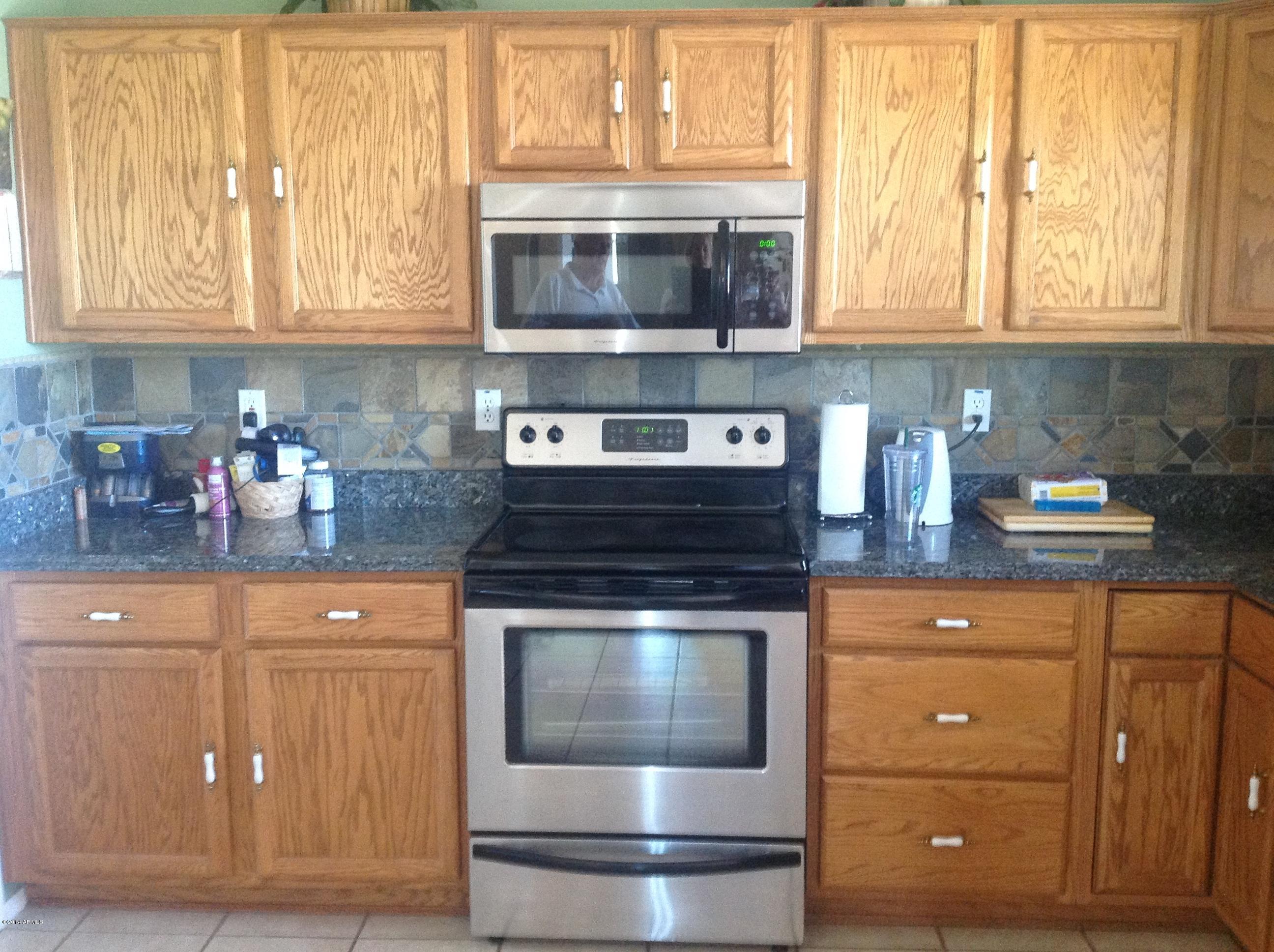 1355 North Acacia Road Apache Junction, AZ 85119 - Photo 8 of 45 a kitchen with stainless steel appliances granite countertop a stove and a microwave