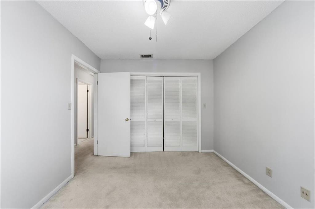 2260 Pernoshal Court Atlanta, GA 30338 - Photo 16 of 46 an empty room with a ceiling fan and window