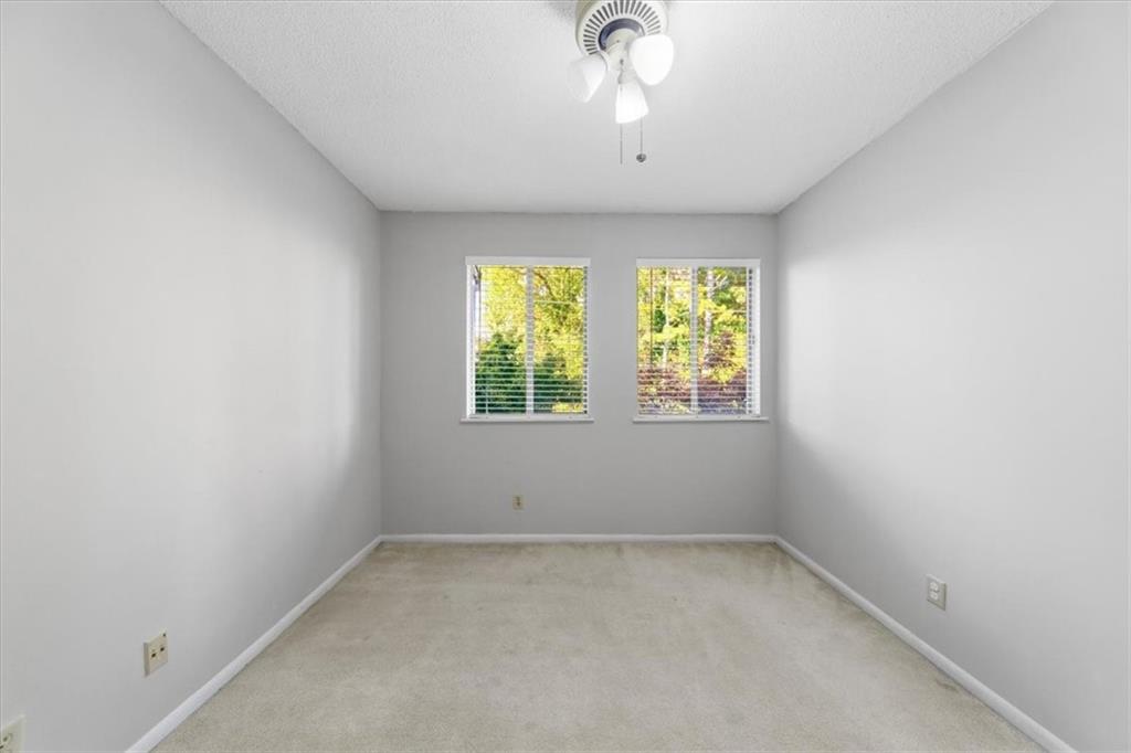 2260 Pernoshal Court Atlanta, GA 30338 - Photo 17 of 46 an empty room with windows and chandelier