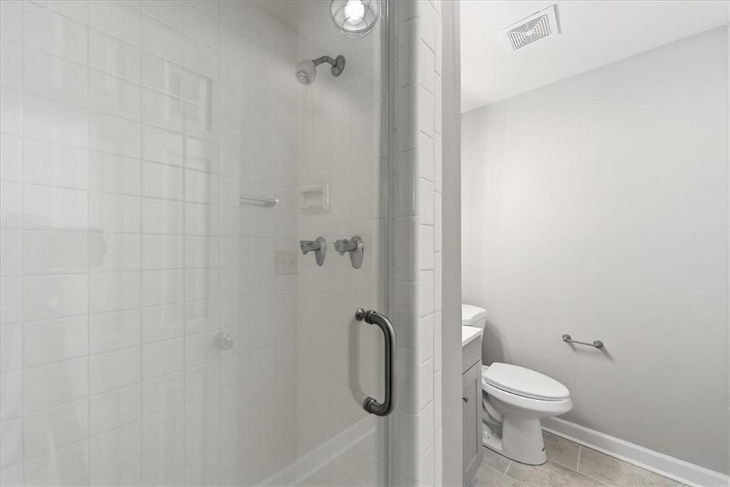 2260 Pernoshal Court Atlanta, GA 30338 - Photo 19 of 46 a bathroom with a granite countertop toilet and a shower