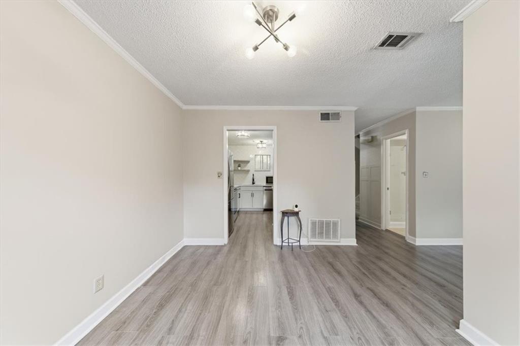 2260 Pernoshal Court Atlanta, GA 30338 - Photo 23 of 46 a view of wooden floor and a chandelier fan in a room