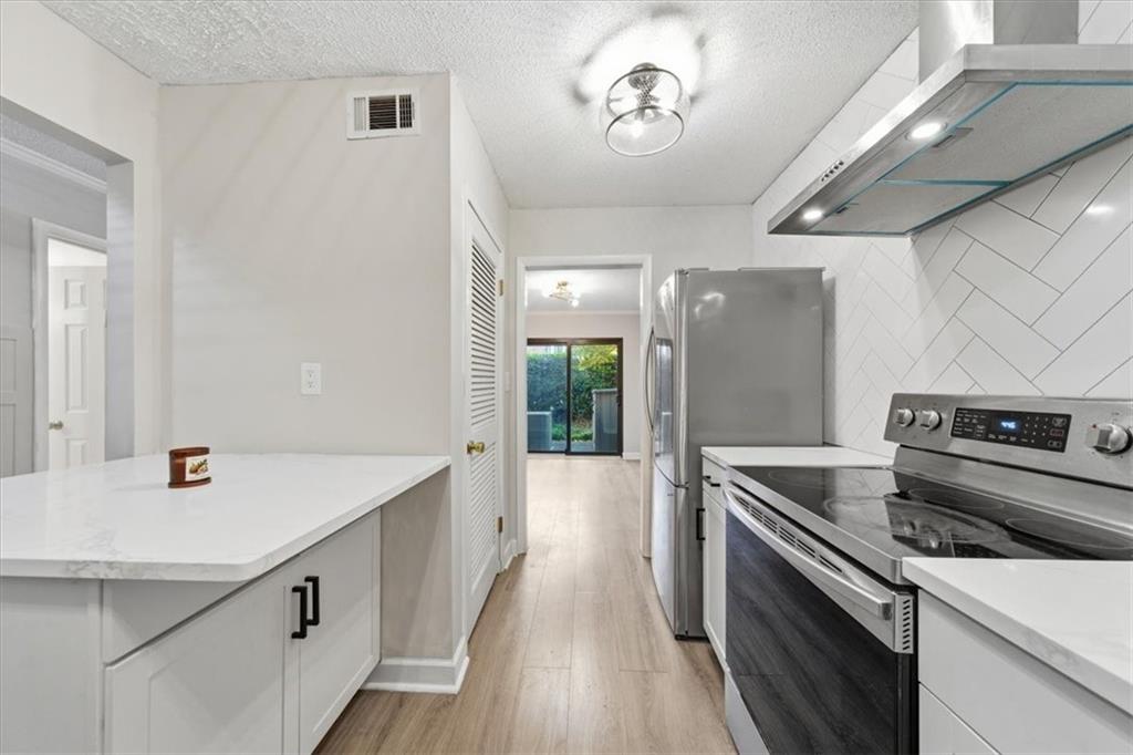 2260 Pernoshal Court Atlanta, GA 30338 - Photo 28 of 46 a kitchen with a sink and stainless steel appliances