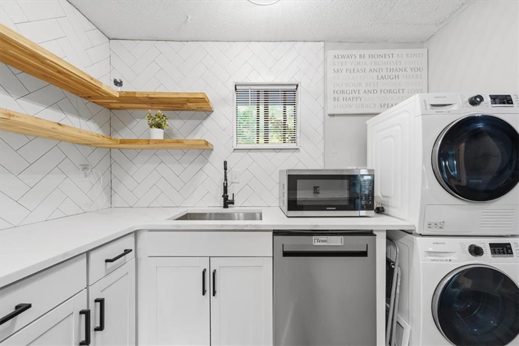 2260 Pernoshal Court Atlanta, GA 30338 - Photo 30 of 46 a kitchen with a stove a sink and a microwave