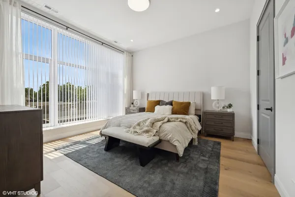 a spacious bedroom with a bed and a window