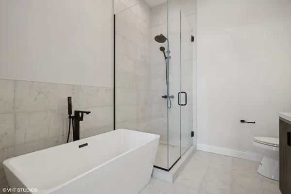 a bathroom with a bathtub and a shower