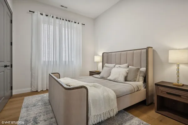 a bedroom with a bed and a night stand