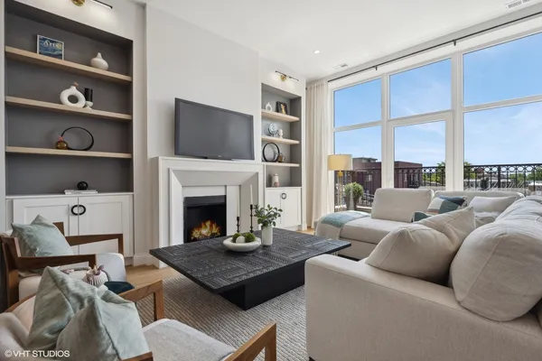 a living room with furniture fireplace and window