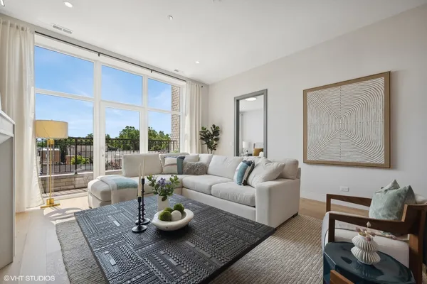 a living room with furniture and a table with garden view