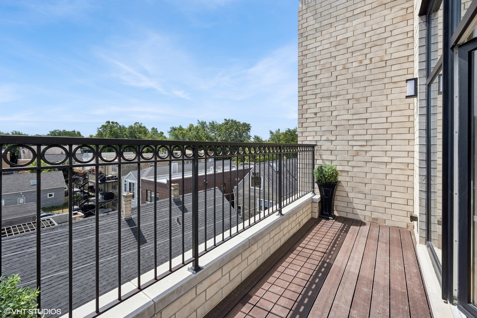 1615 West Irving Park Road, Unit 1S Chicago, IL 60613 - Photo 10 of 19 a view of balcony with wooden floor and fence