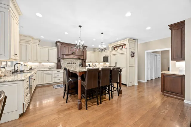 a kitchen with kitchen island granite countertop a stove and a center island