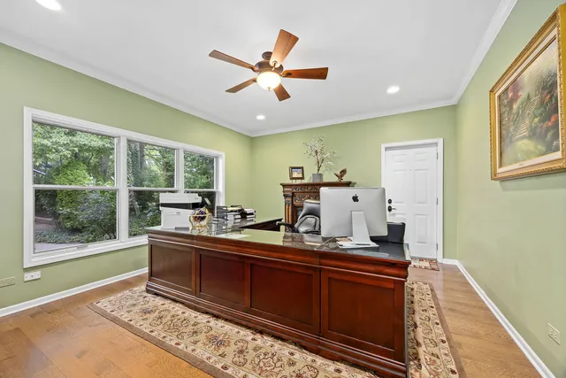 a bathroom with a granite countertop sink a toilet a mirror and shower