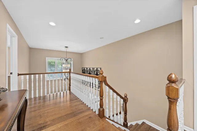 a spacious bedroom with a bed and a chandelier