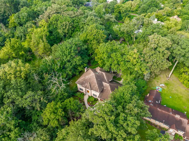 a view of a house with pool and chairs