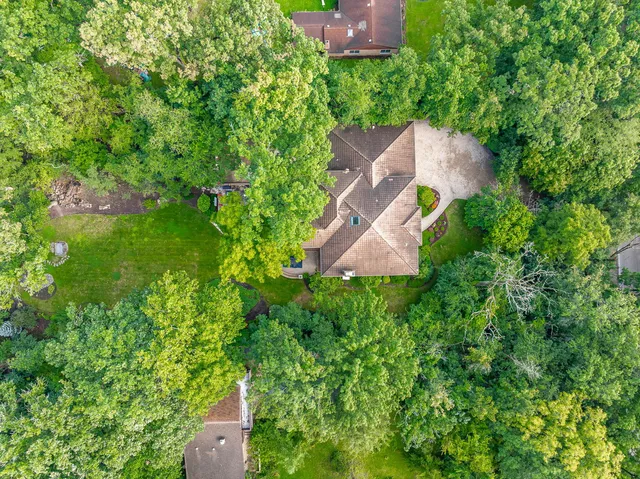 a front view of a house with swimming pool and garden