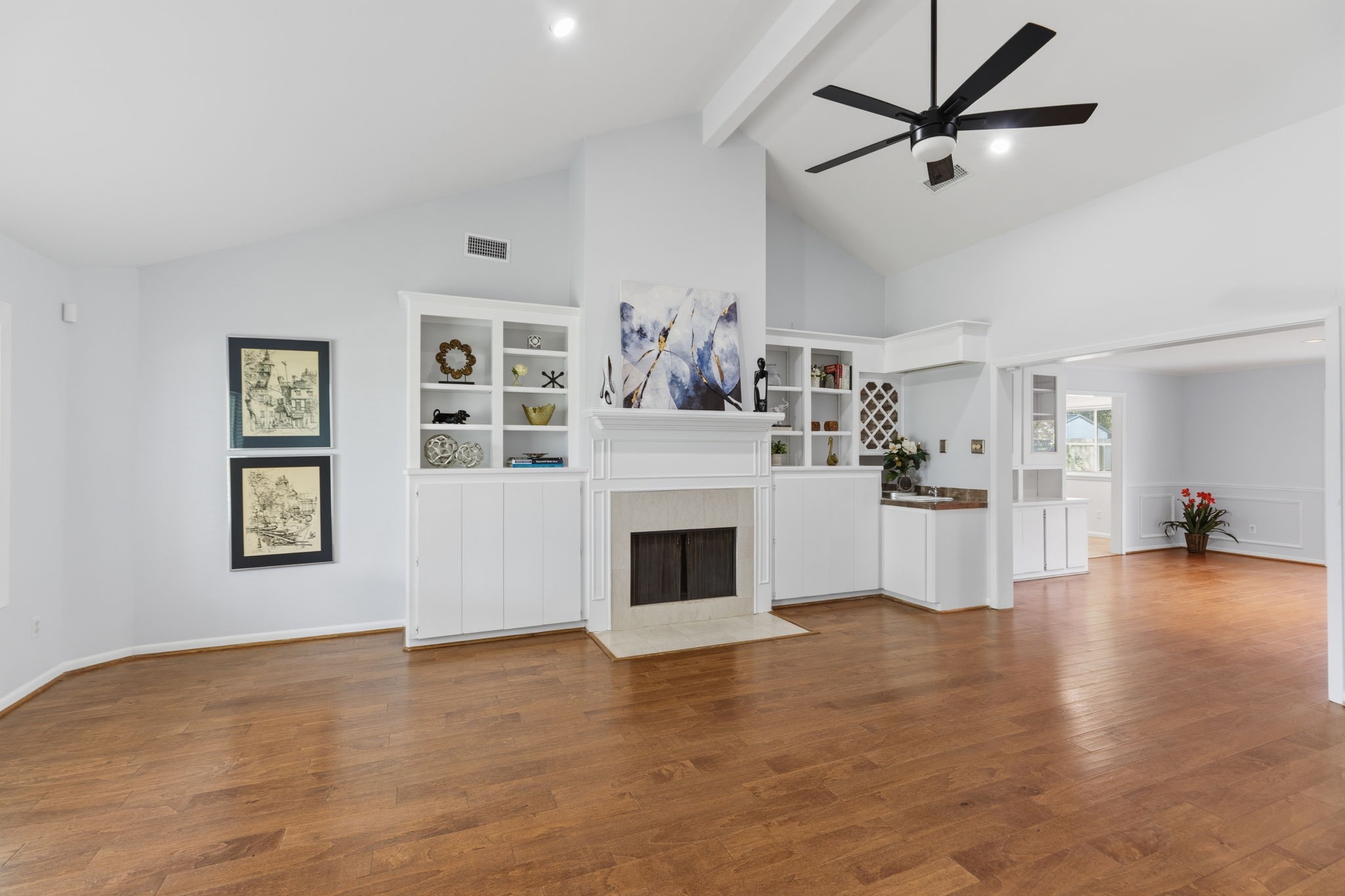 5410 Indigo Street Houston, TX 77096 - Photo 5 of 30 Gleaming floors and high ceiling with stately fireplace and built ins in living area and classic open flow to dining area.