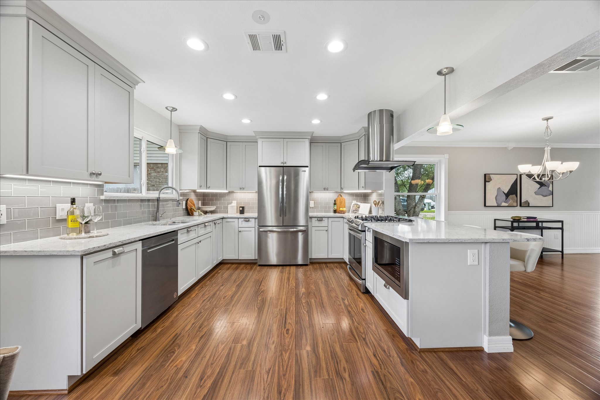 1306 Shady Grove Path Cedar Park, TX 78613 - Photo 13 of 40 a kitchen with white cabinets and stainless steel appliances