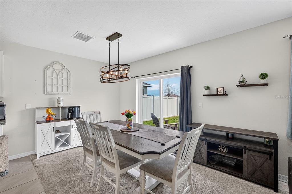 1809 Myrtlebrooke Drive Edgewater, FL 32141 - Photo 15 of 58 a view of a dining room with furniture and window