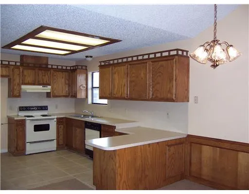 a kitchen with stainless steel appliances granite countertop a stove and a sink