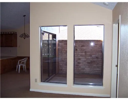 a bathroom with a glass shower door and a window