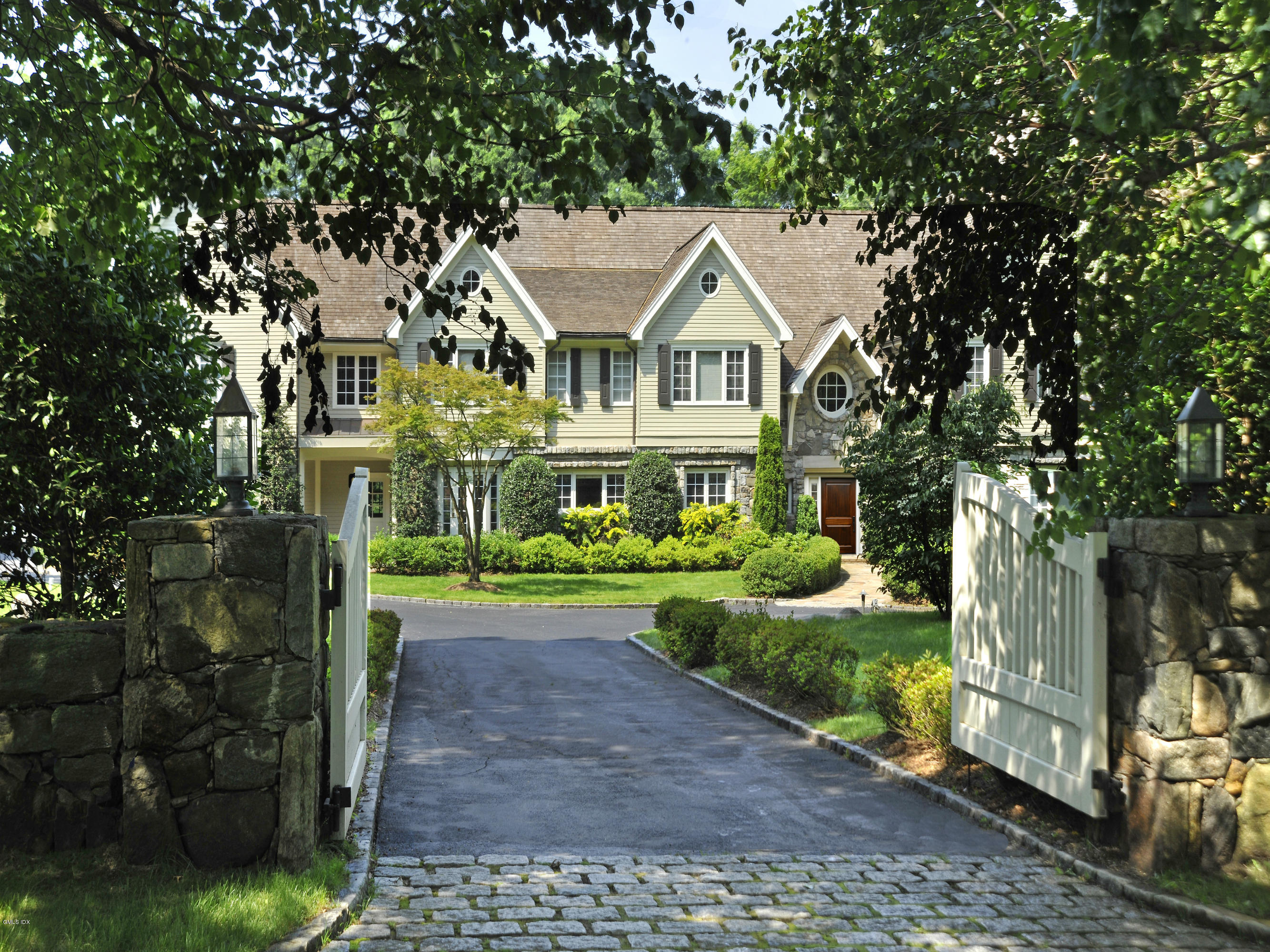 80 Clapboard Ridge Road Greenwich, CT 06830 - Photo 26 of 27 a front view of a house with a garden