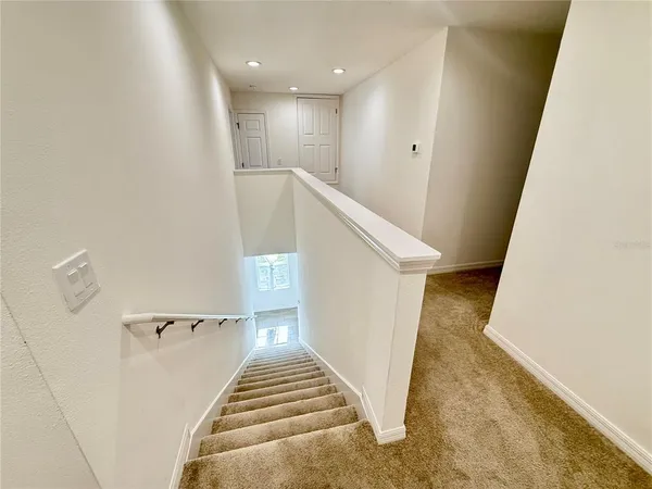 a view of a hallway with stairs