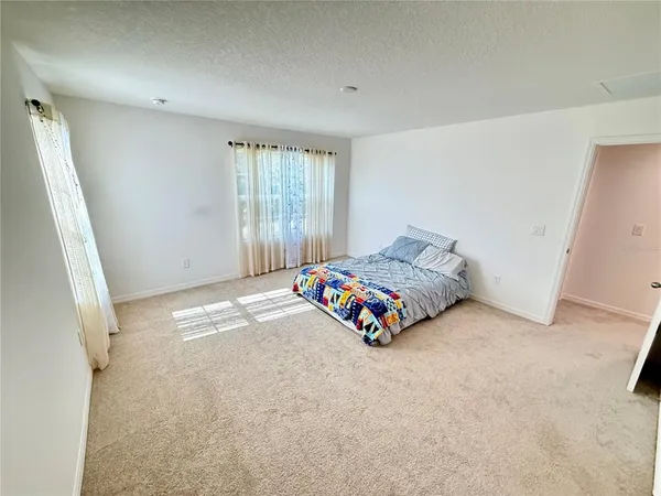 a bedroom with a bed and a couch