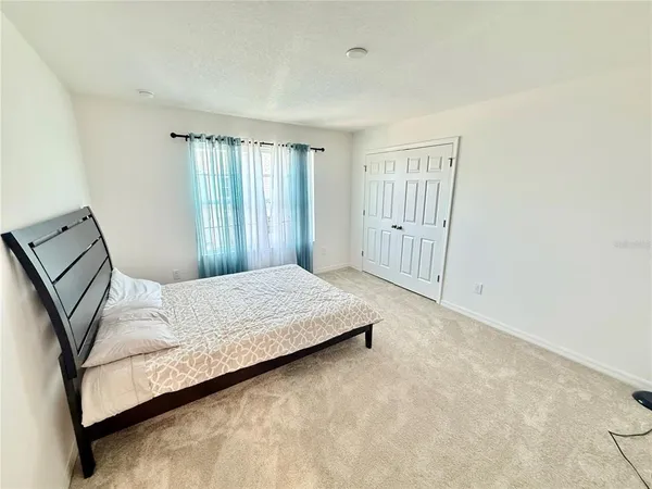 a bedroom with a bed and window