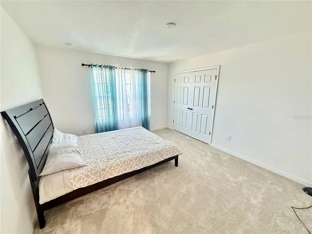 a bedroom with a bed and window