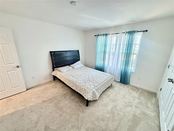 a spacious bathroom with a granite countertop sink and a mirror