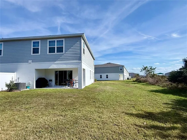 a big house with a big yard and large trees