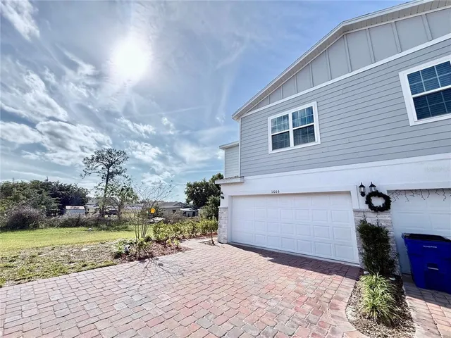 a front view of a house with a yard and a garage