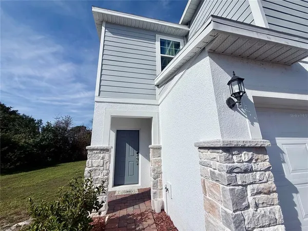 a front view of a house with plants