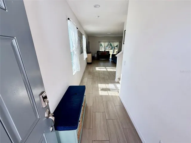 a view of hallway with wooden floor