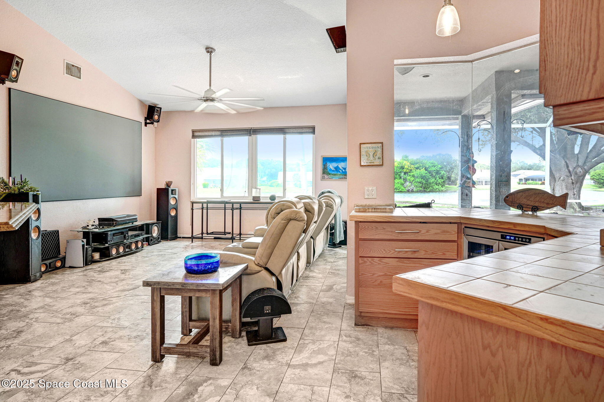 4073 Sand Ridge Drive Merritt Island, FL 32953 - Photo 17 of 66 a kitchen with sink refrigerator dining table and chairs