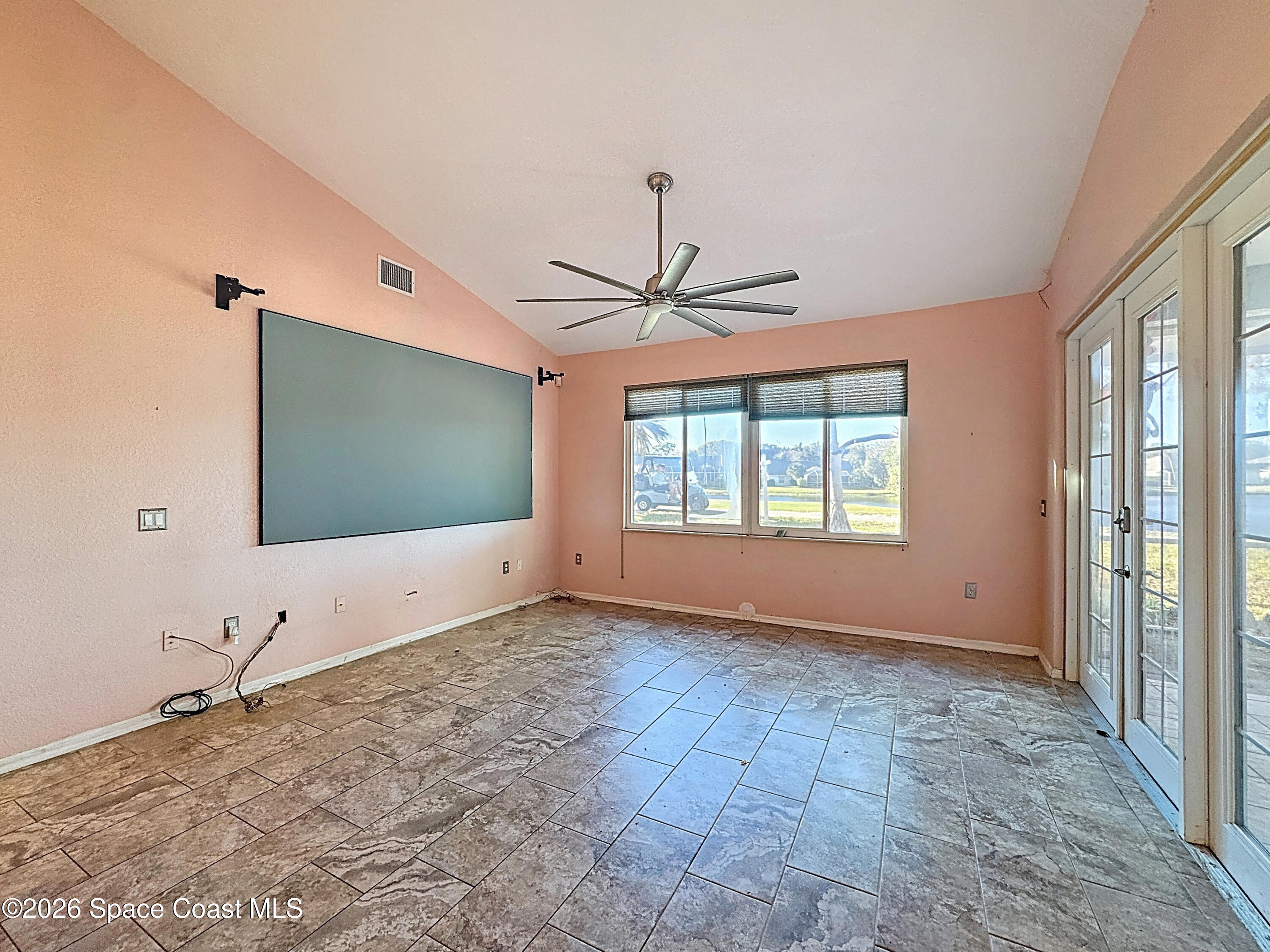 4073 Sand Ridge Drive Merritt Island, FL 32953 - Photo 18 of 66 a view of an empty room with window and chandelier fan