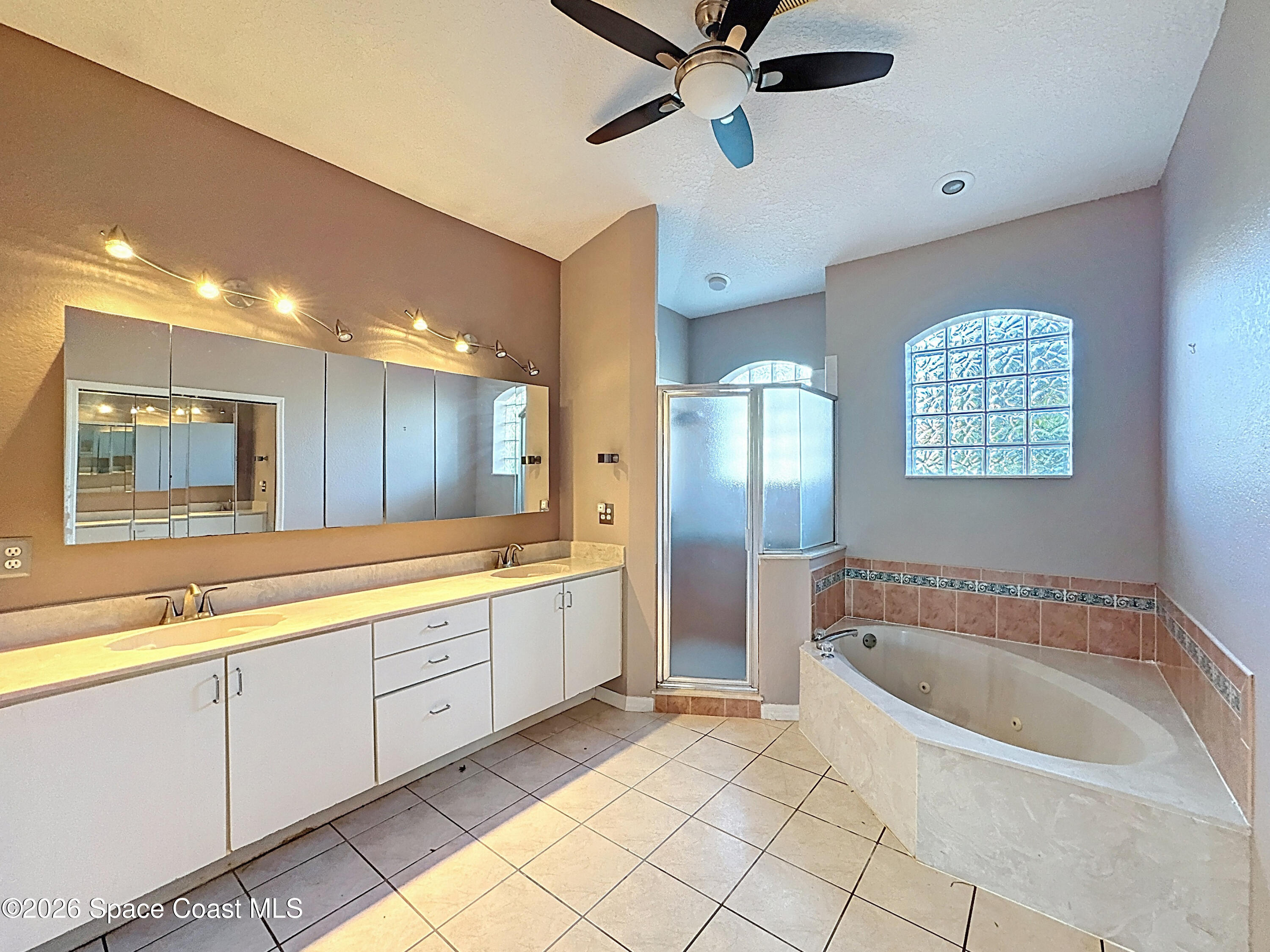 4073 Sand Ridge Drive Merritt Island, FL 32953 - Photo 26 of 66 a spacious bathroom with a tub a sink and mirror