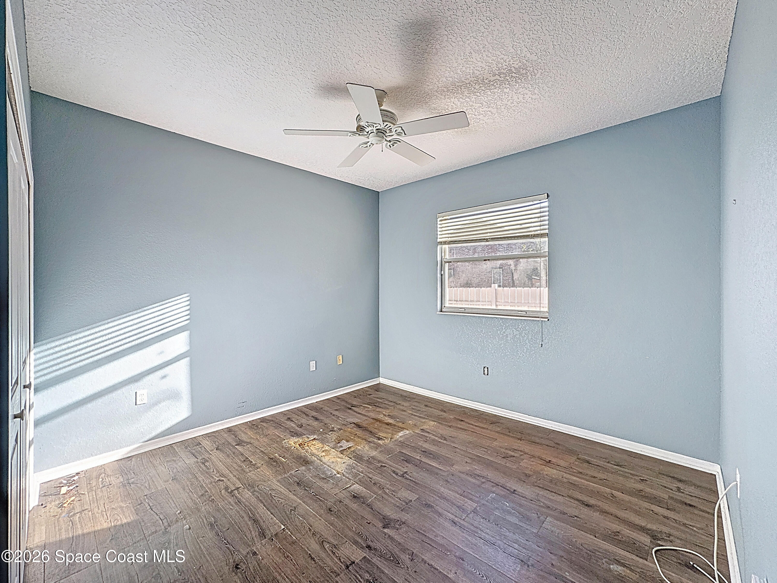 4073 Sand Ridge Drive Merritt Island, FL 32953 - Photo 27 of 66 wooden floor in an empty room with a window