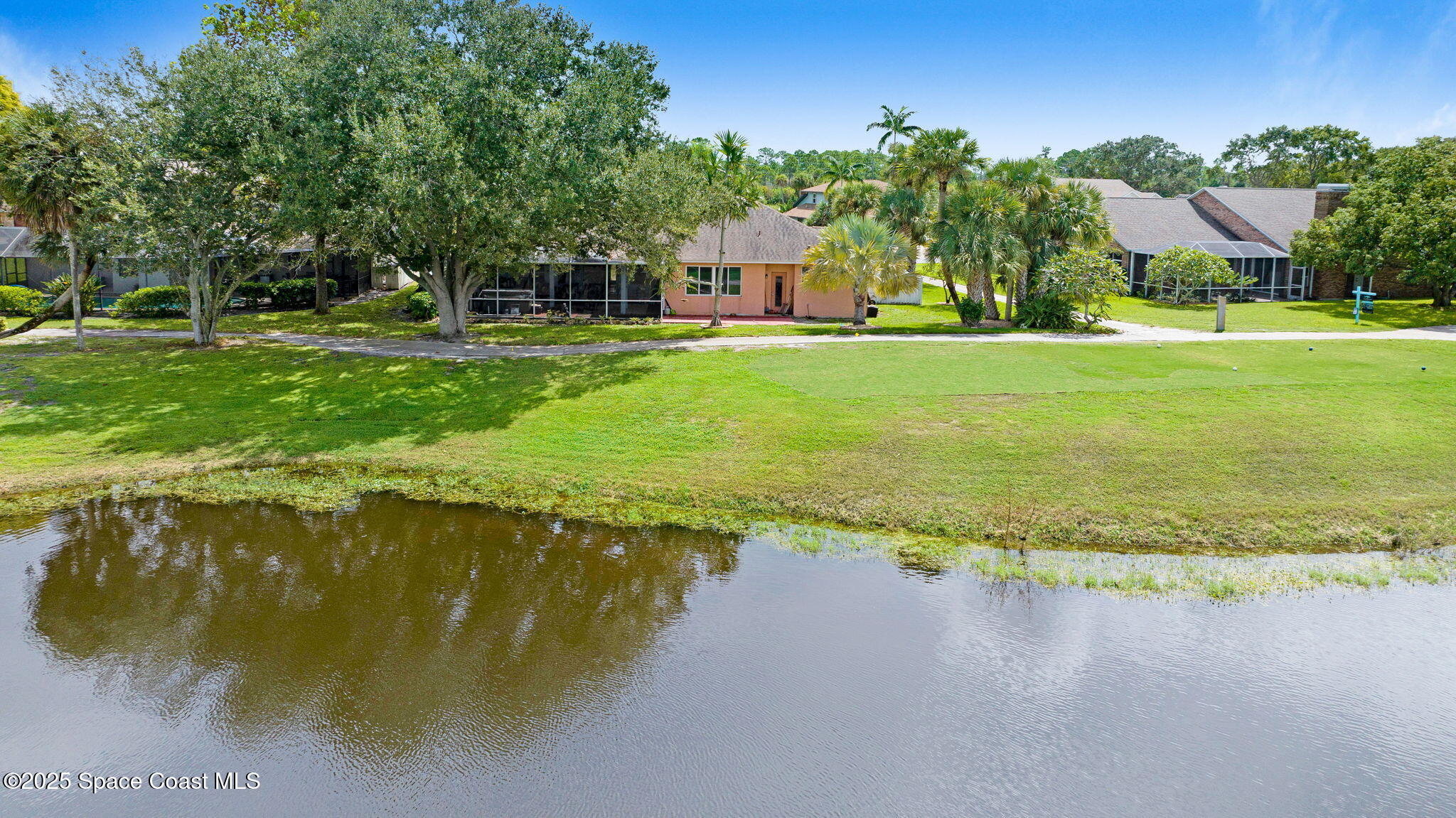 4073 Sand Ridge Drive Merritt Island, FL 32953 - Photo 40 of 66 a swimming pool with trees in the background