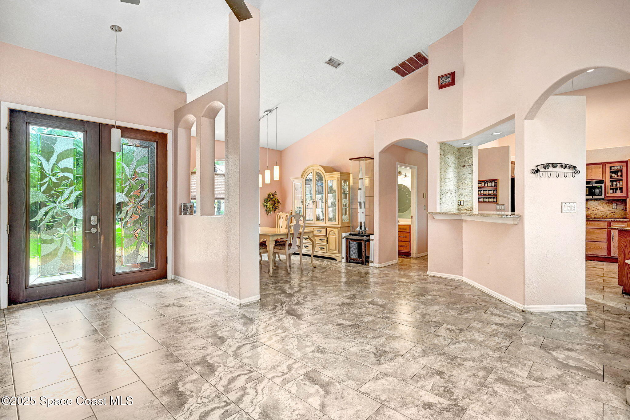 4073 Sand Ridge Drive Merritt Island, FL 32953 - Photo 4 of 66 a view of a big room with windows and chandelier