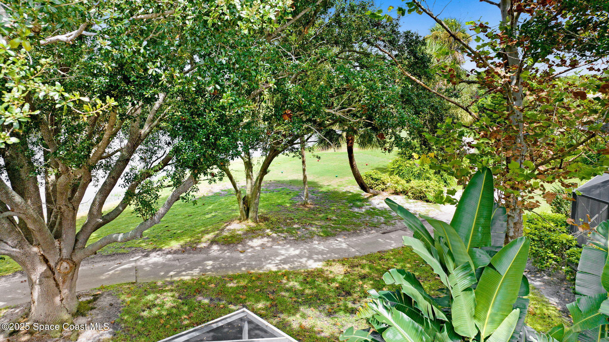 4073 Sand Ridge Drive Merritt Island, FL 32953 - Photo 42 of 66 a backyard of a house with lots of green space