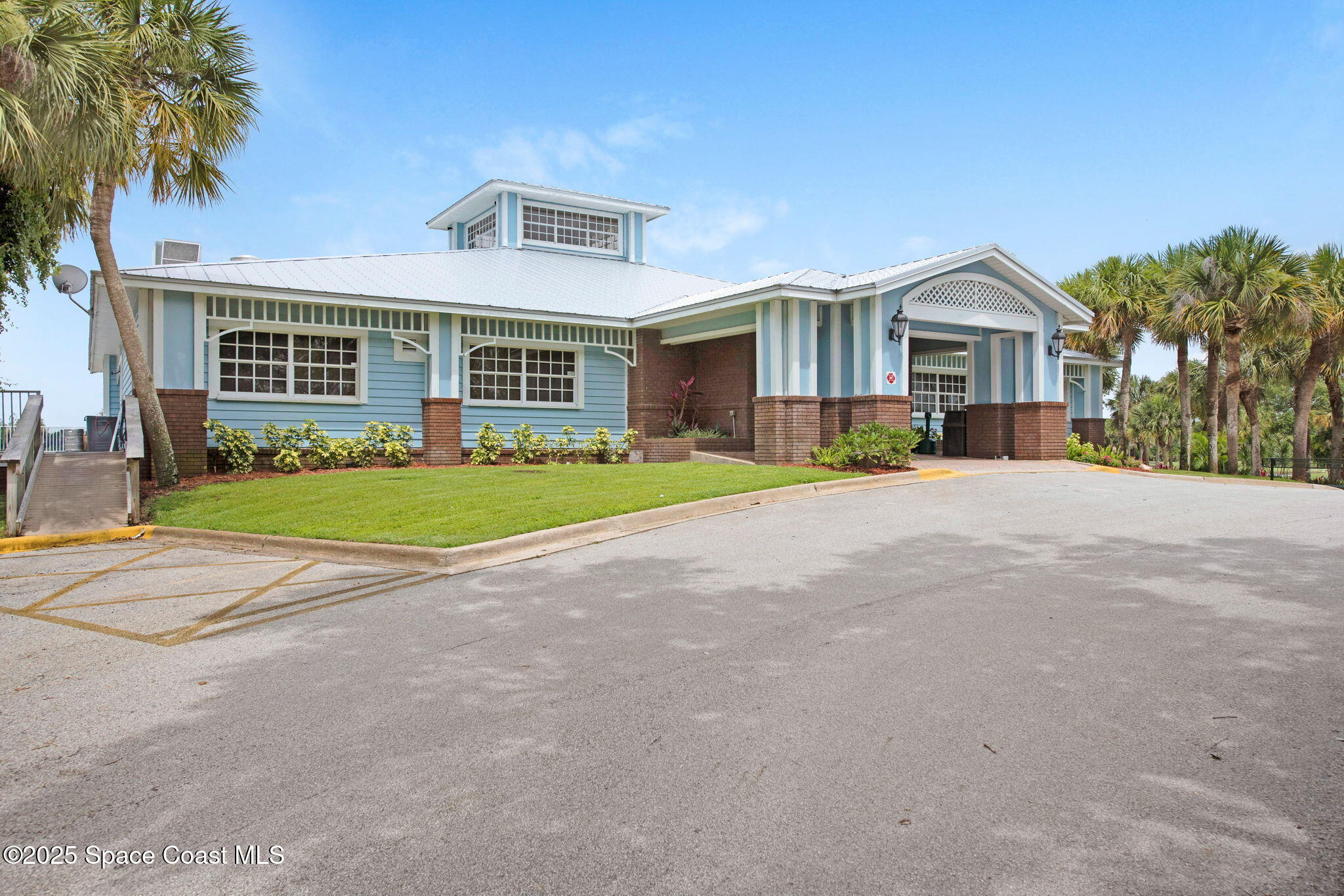 4073 Sand Ridge Drive Merritt Island, FL 32953 - Photo 44 of 66 a front view of a house with a yard and trees