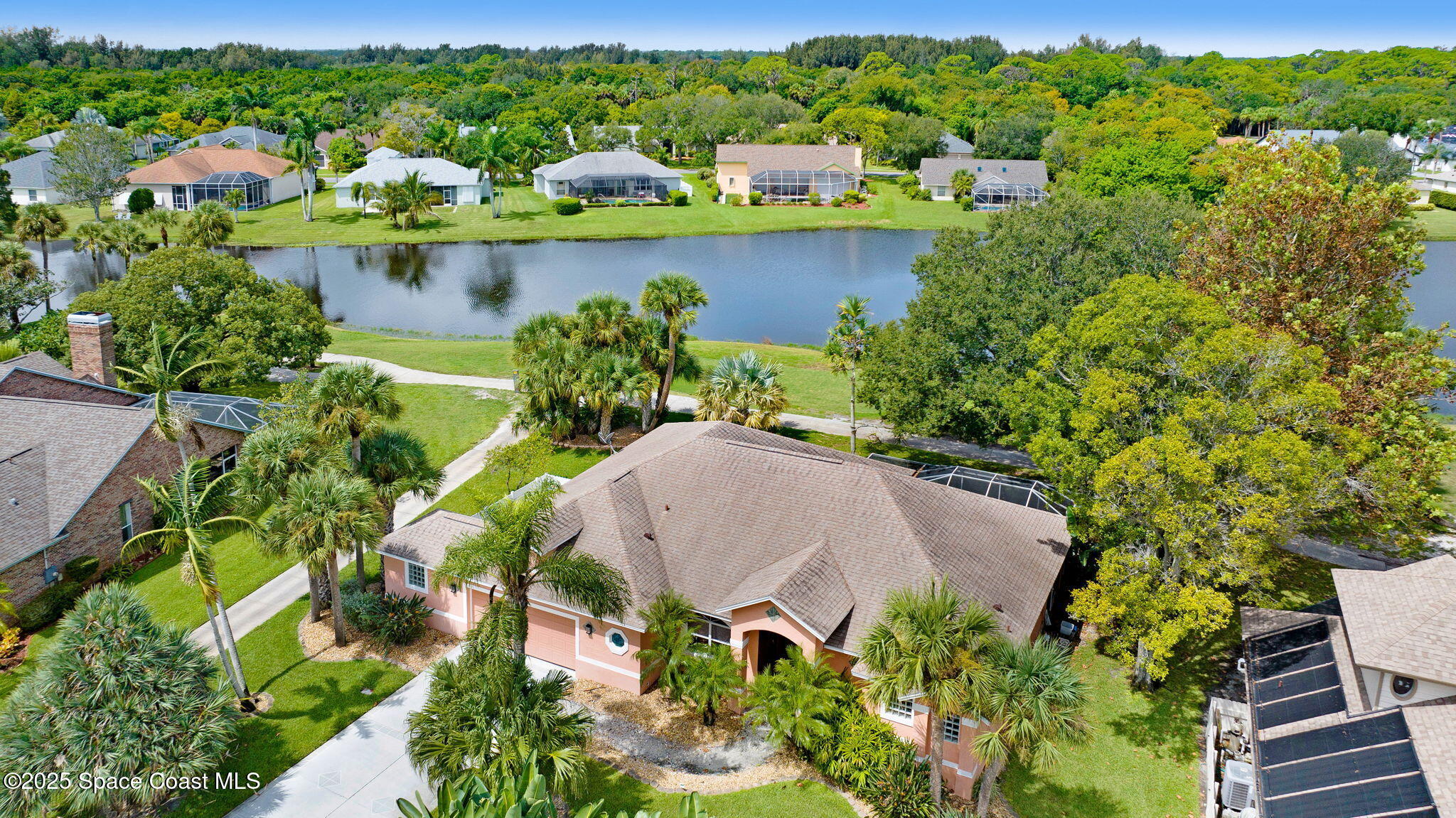 4073 Sand Ridge Drive Merritt Island, FL 32953 - Photo 54 of 66 an aerial view of a house with a yard and lake view